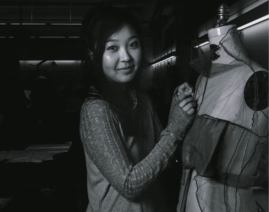 Woman pinning fabric to a dress form to make her own design