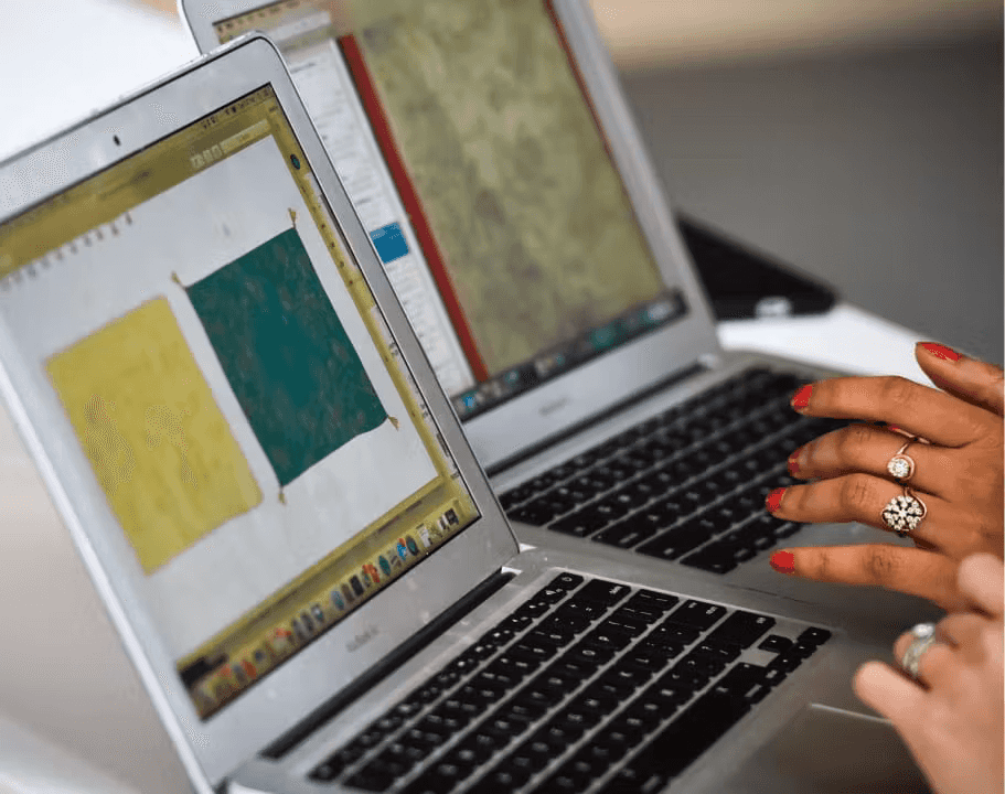 Two people collaborating on fashion designs on their laptops